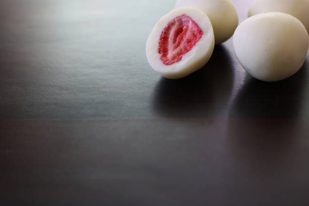 istock chocolate coated dried strawberries in a wooden background 1303555466