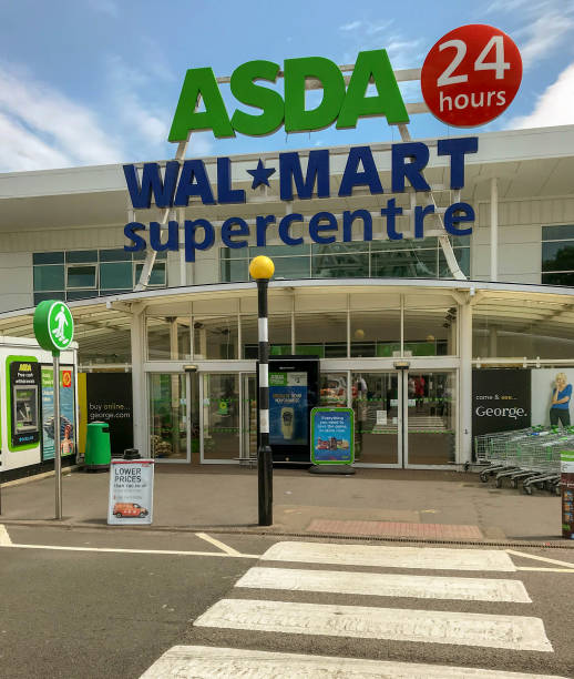 Entrance to an Asda supermarket Cardiff, Wales - July 2018: Exterior of a 24 hour Asda Walmart store and car park asda photos stock pictures, royalty-free photos & images