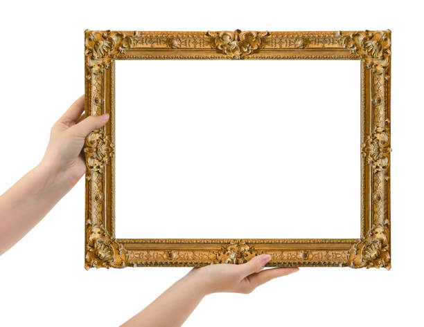 istock Wooden picture frame in hands 1303558260