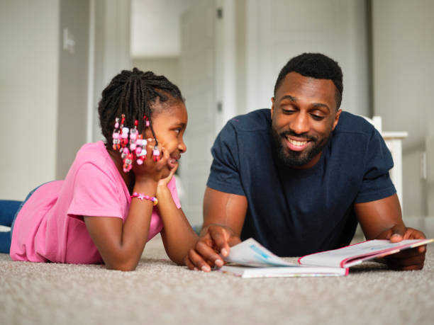 istock Dad and Daughter Reading a Book 1303558594