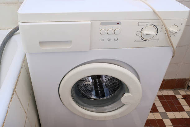 istock An old broken washing machine in a bathroom need to be recycled and replaced 1303559275