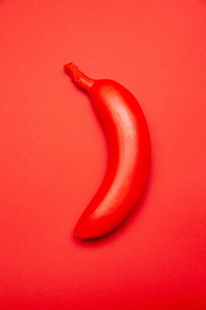 istock Red colored tropical banana on bright surface 1303560599