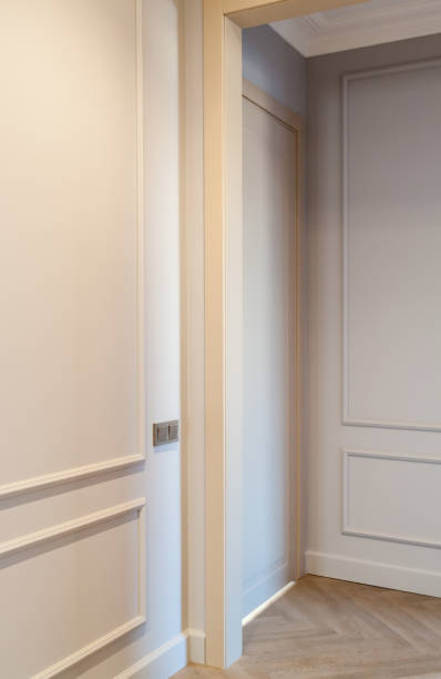 istock Close up view of modern and bright interior of empty cream colored corridor with herringbone parquet floor 1303562696