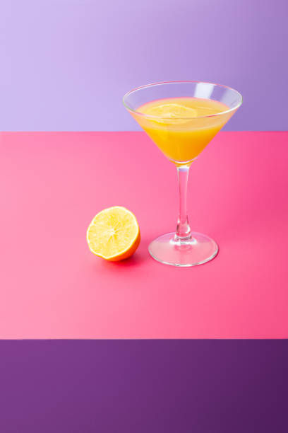 istock Refreshing yellow lemon cocktail in glass on table 1303563210