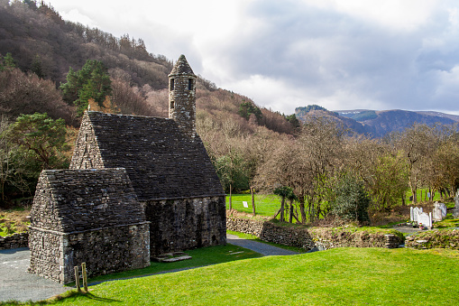 Traditional Irish Rock Church on Green rolling Hills in Glendalough in the countryside of Northern Ireland