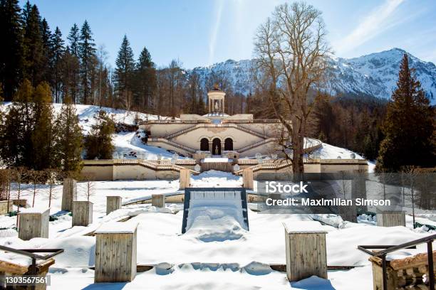 Linderhof Castle Palace In The German Snow Covered Alps On A Sunny Winter Day In Bavaria A Popular Tourist Destination In The European Austrian Mountains Its A Fountain In The Summer Time And A Winter Wonderland In The Cold Season Stock Photo - Download Image Now