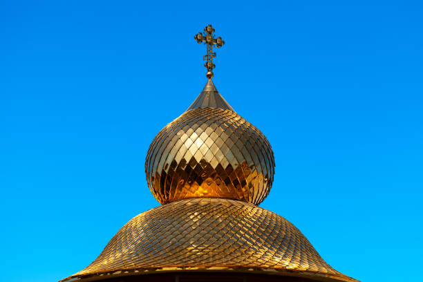 Church dome golden colored with cross on the top
