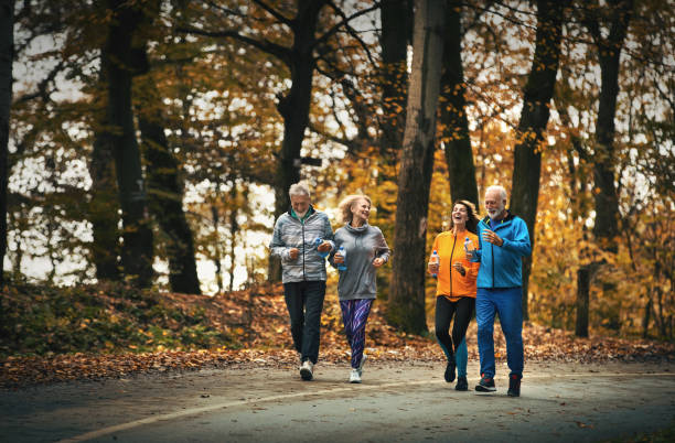 istock Group of mature folks jogging in a forest. 1303570438