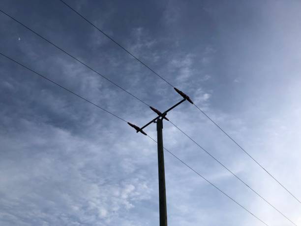 istock Electricity pole in front of fleecy clouds 1303571284