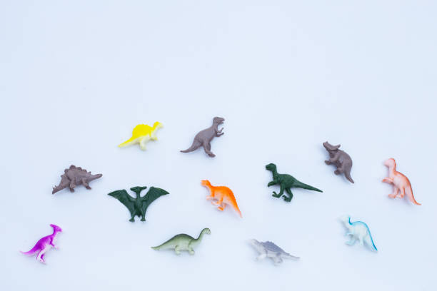 Plastic mass produced toy dinosaurs attacking technology. This a concept image for 'Don't Be A Dinosaur' or a Luddite theme.
