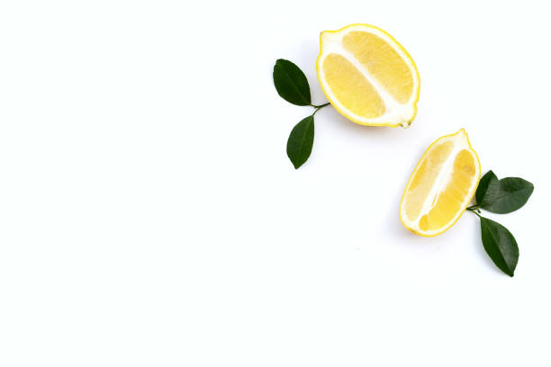 istock Fresh lemon with green leaves on white. 1303571993