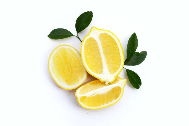 istock Fresh lemon with green leaves on white. 1303572010