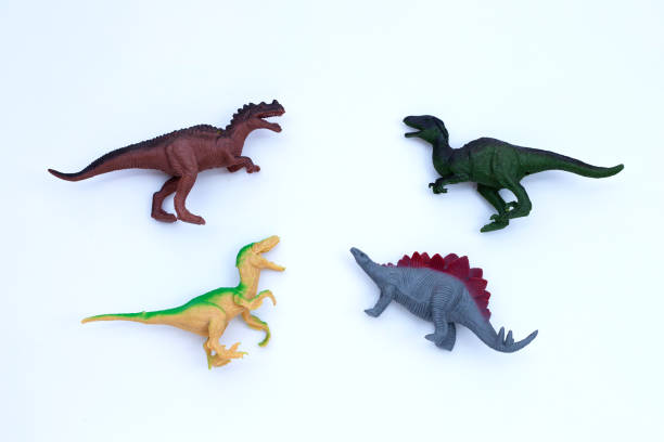 istock Plastic dinosaur toys on white background. Top view 1303572270