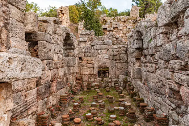 Photo of Part of residential building in historical city of Olympus, Byzantine period. Amazing nature and antique city ruins. Ruins of an ancient city in Lycia, near village of Cirali, 70 km from Antalya.