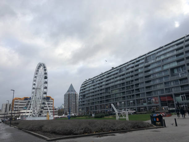 istock Ferry wheel and large building 1303575369