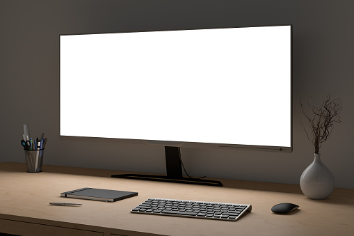 Glowing wide screen display mock up. Workspace at night with the wooden desk and white wall. Side view. 3d illustration