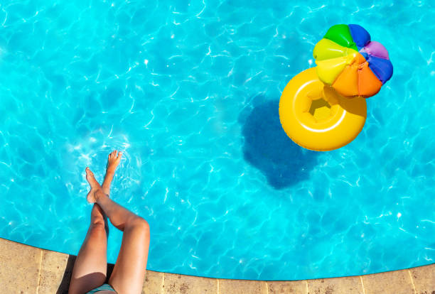 istock Woman's legs, inflatable ring swim in pool 1303581856