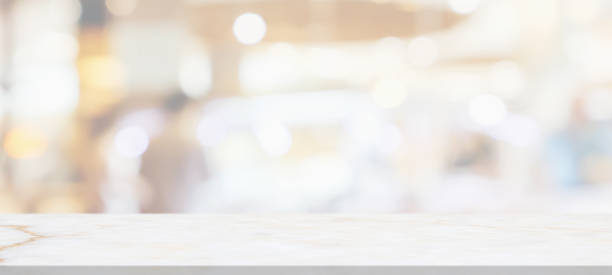 istock marble table top with blurred abstract cafe restaurant interior background 1303581983
