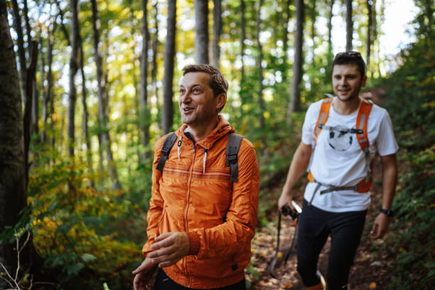 istock Happy male hikers in autumn forest 1303583889