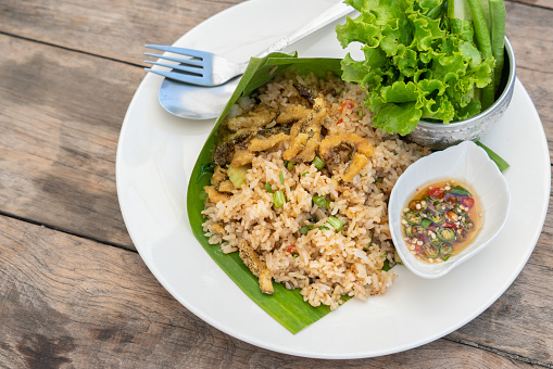 Traditional Thailand food, Kaw Pad Nam Prick Pra Salid or Stired fried rice with chilli paste, topping with deep fried fish