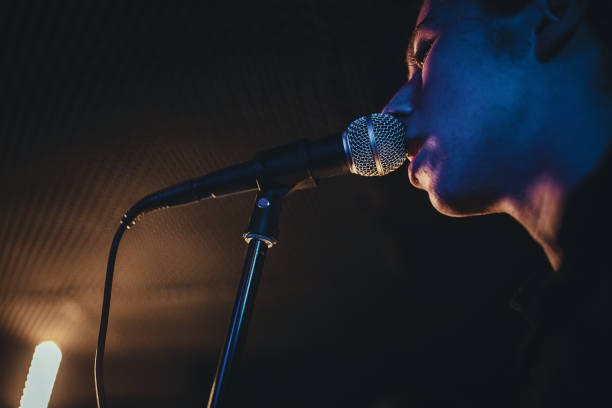 One man, male vocalist singing in music bend, he is on rehearsal.
