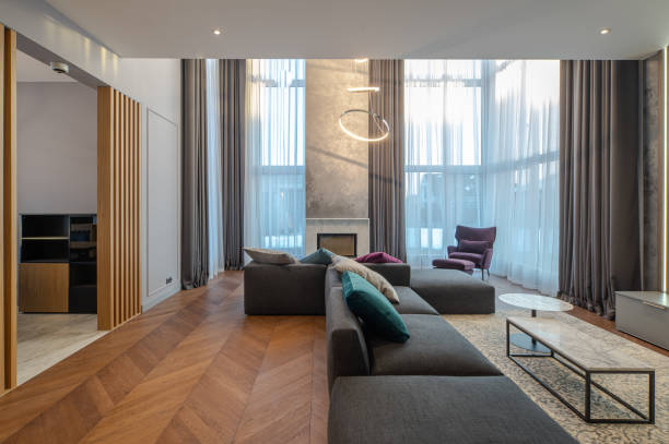 istock Luxury private house interior. Living room. Huge cozy sofa. Fireplace. 1303590246