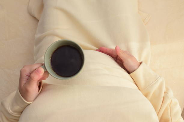 istock pregnant woman with a mug 1303590303