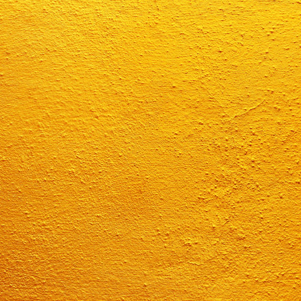 istock gold or yellow paint on rough cement wall texture 1303594303