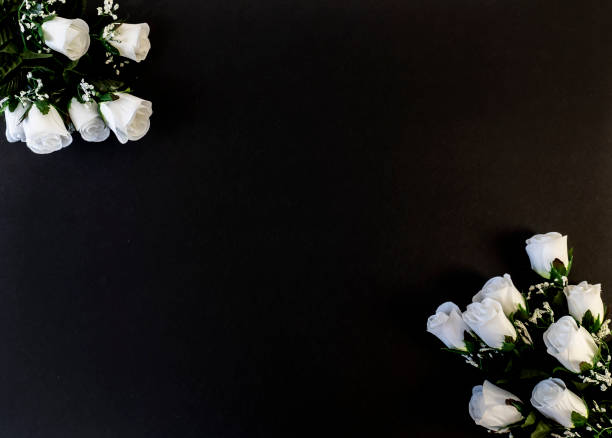 istock Flat Lay, postcard for death, funeral. White roses on a black background 1303595214