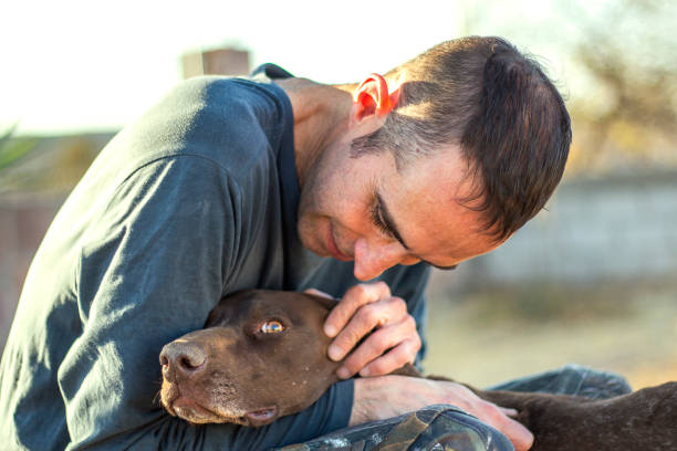 istock Man with his dog outdoors 1303597737