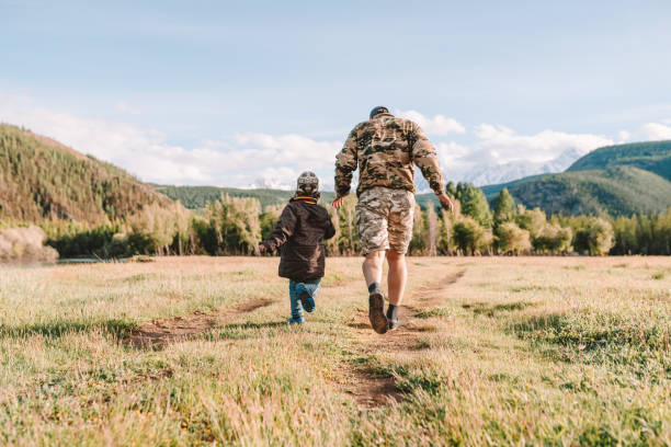 istock father and son walking in the countryside 1303598736