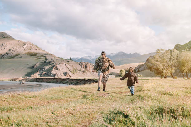 istock father and son walking in the countryside 1303598737