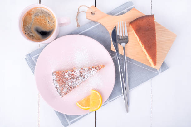 istock Two pieces of pie on a pink plate and a cutting board 1303599407