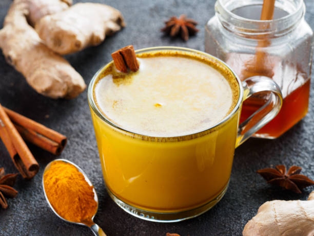 istock golden turmeric latte and ingredients, copy space 1303603521