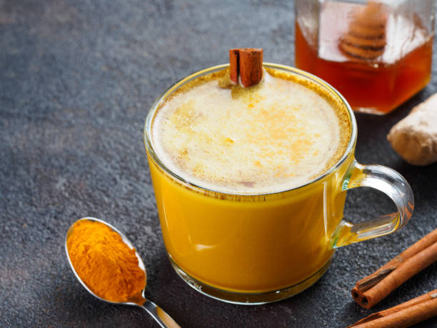 istock golden turmeric latte and ingredients, copy space 1303603536