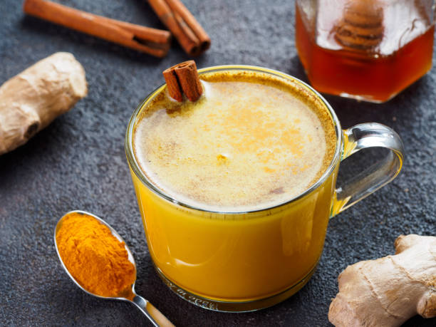 istock golden turmeric latte and ingredients, copy space 1303603540