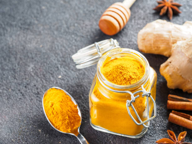 istock turmeric powder in glass jar and spoon 1303603568
