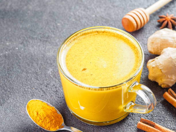 istock golden turmeric latte and ingredients, copy space 1303603582