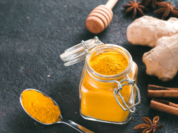 istock turmeric powder in glass jar and spoon 1303603614