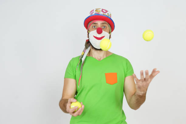 istock The clown juggles balls. Isolated on white 1303604465