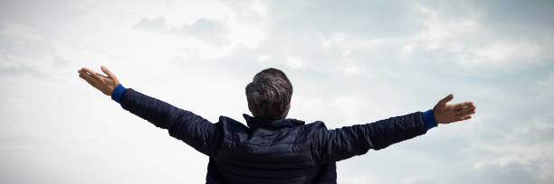 istock Composite image of rear view of a man stretching 1303608419