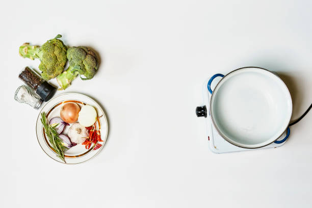 Cooking healthy food with broccoli on portable electric stove