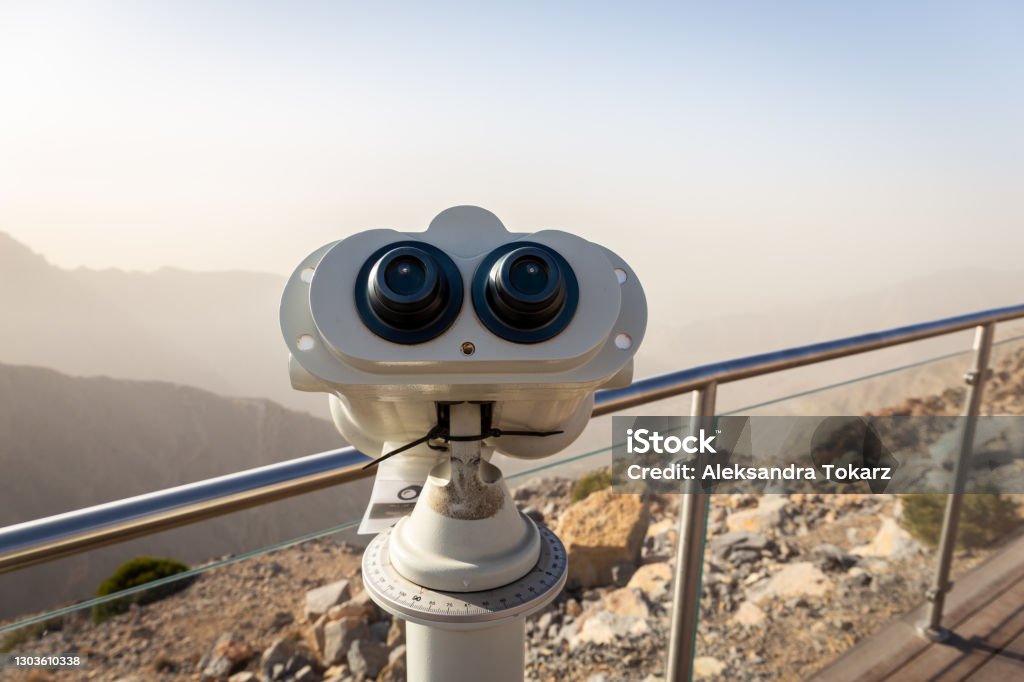 Coin operated binoculars at Jebel Jais Viewing Deck Park overlooking Hajar Mountains, UAE. Boardwalk Stock Photo