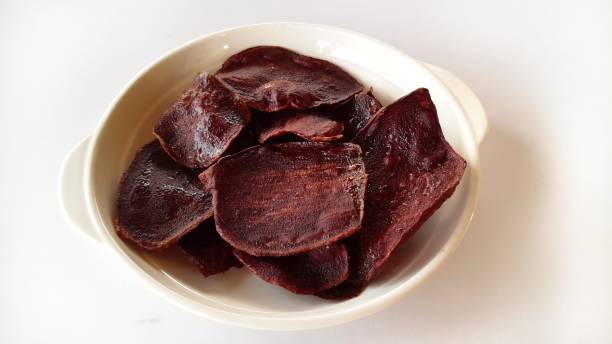 istock Purple potato chip on white background. 1303612848