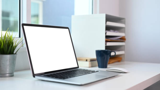 istock Close up view of computer laptop with blank screen on modern office desk. 1303613748