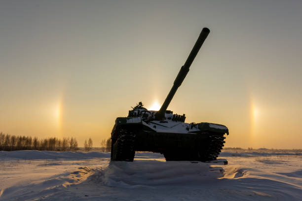 Modern military tank on the background of a solar halo effect. The concept of reducing the world arms race. Modern military tank on the background of a solar halo effect. sundog stock pictures, royalty-free photos & images
