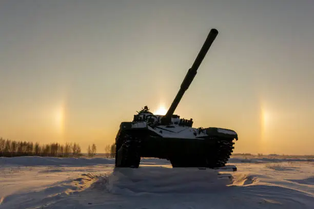 Modern military tank on the background of a solar halo effect.