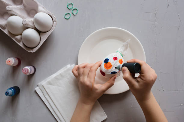 istock DIY and kids creativity. Step by step instruction: how to make painted easter eggs. Top view, flat lay. Step 5 1303614717