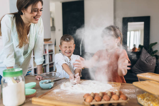 istock children baking with their mother at home 1303617042