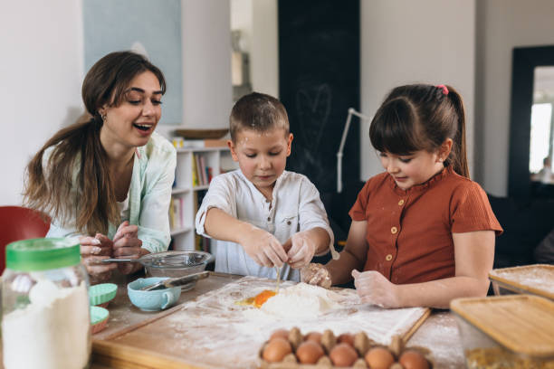 istock children baking with their mother at home 1303617338